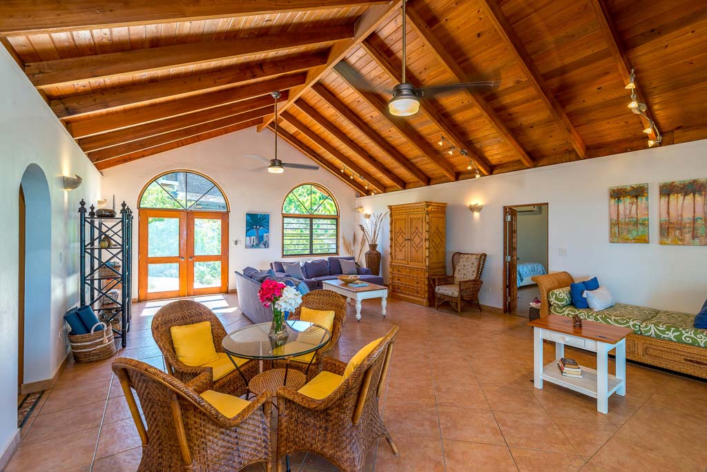 Spacious main room at Sea Palms Villa with tile floors, lofted ceiling and separate sitting, dining and entertaining areas.