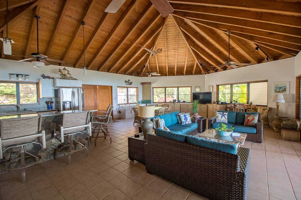 Loblolly Villa’s airy main room with an open kitchen with an island bar and separate dining, living and entertaining areas.