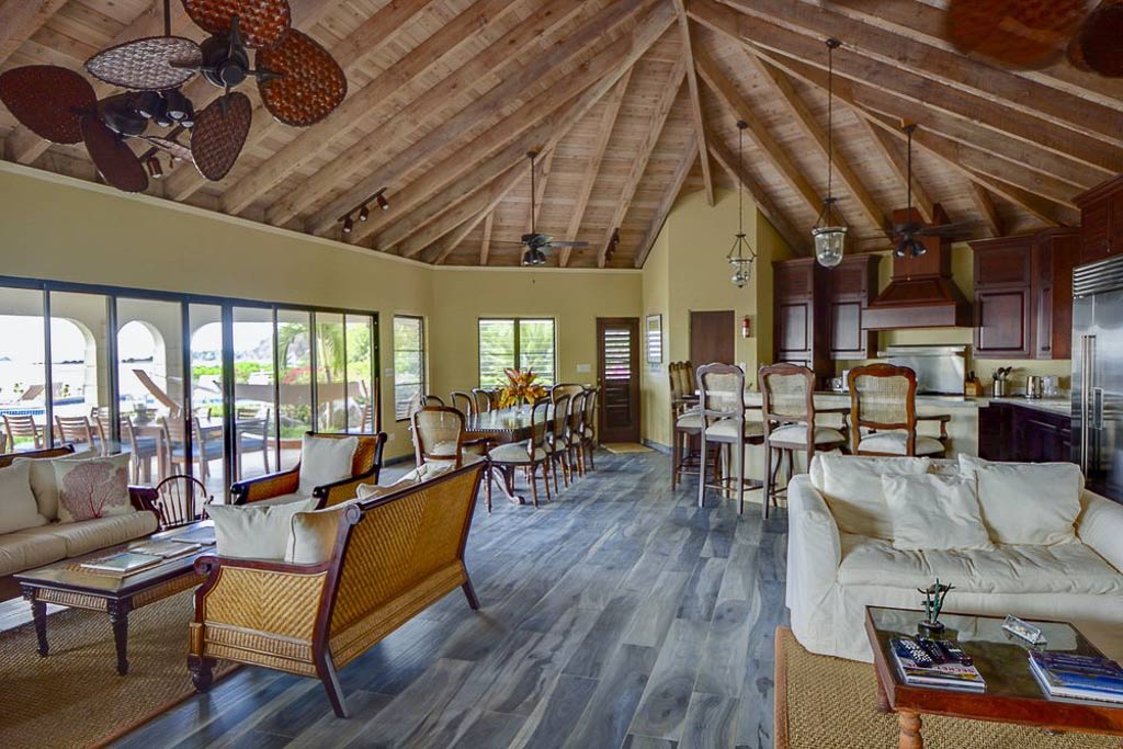 Sandcastle Villa’s large main room with an open kitchen with a bar and separate dining, living and entertaining areas.